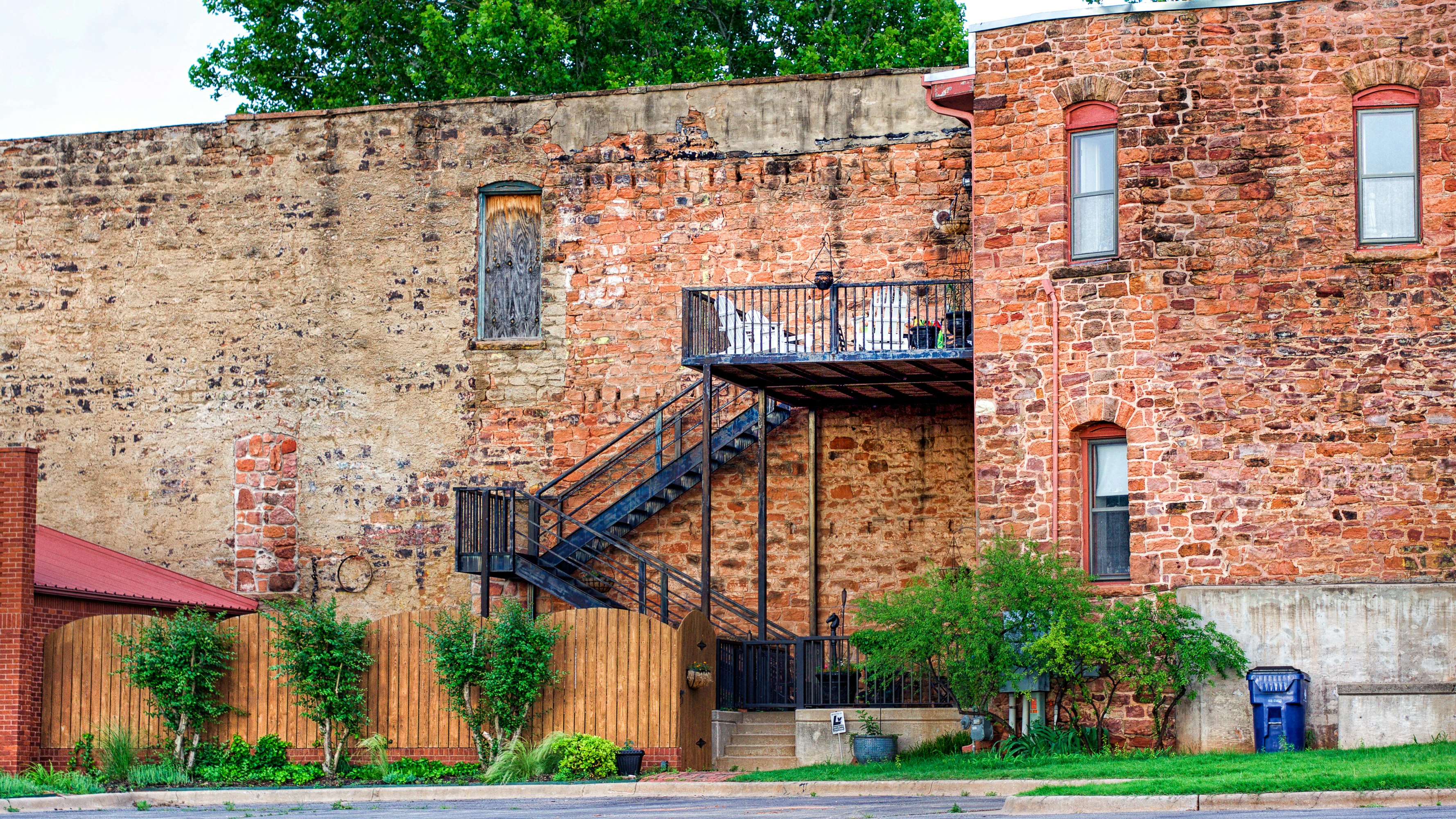 brown brick building with black metal railings